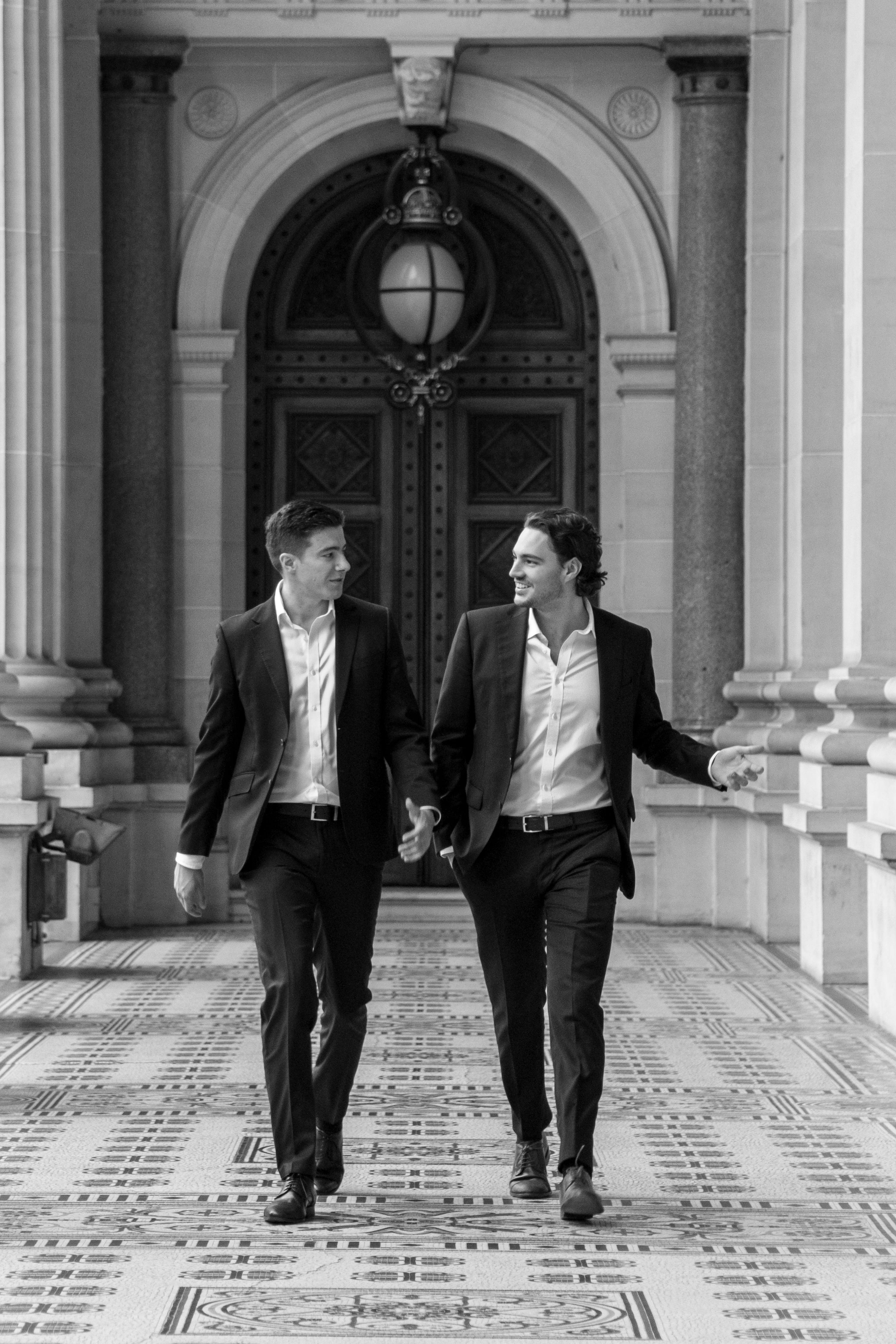Colossal Finance co-founders Hunter Silk and Rupert McLean walking through a Melbourne colonnade